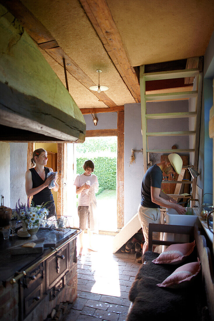 Family doing the dishes, Klein Thurow, Roggendorf, Mecklenburg-Western Pomerania, Germany