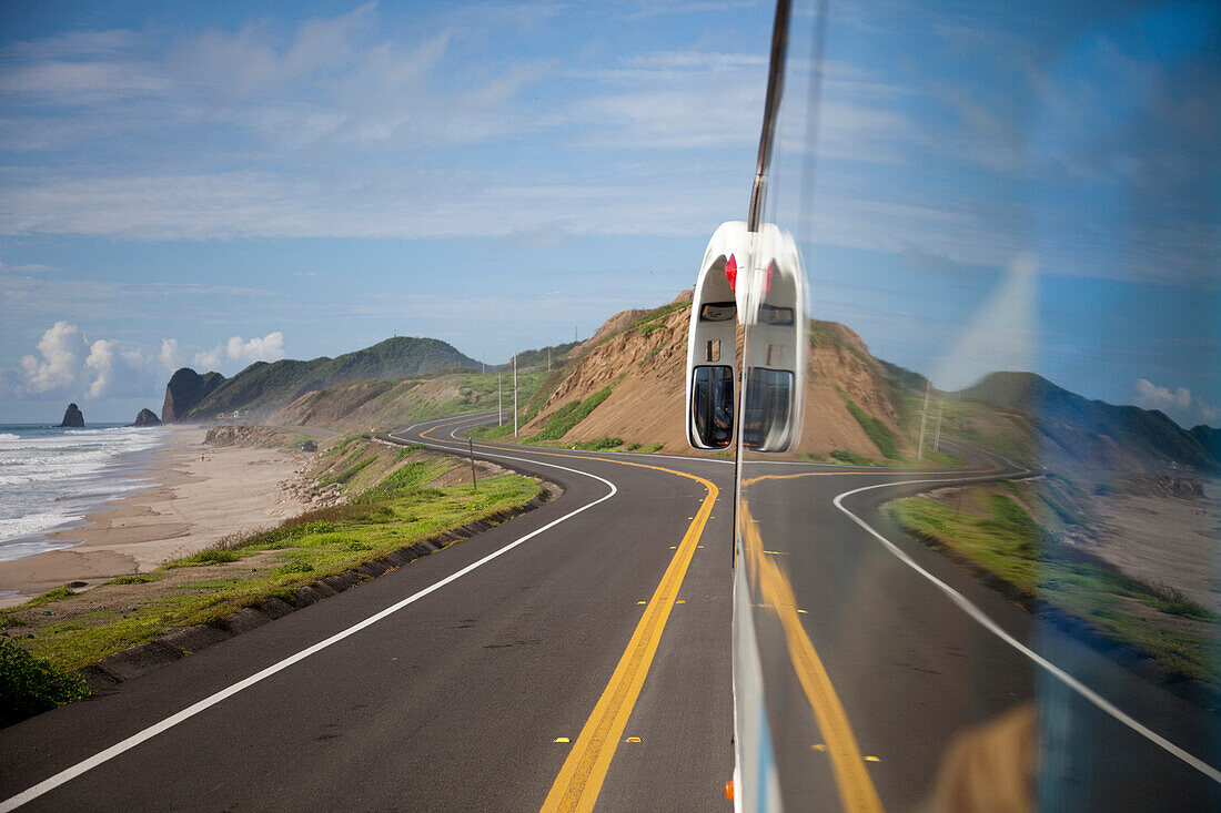Window reflection on tour bus along Panamericana Pacific coast highway, near Manta, Manabi, Ecuador, South America