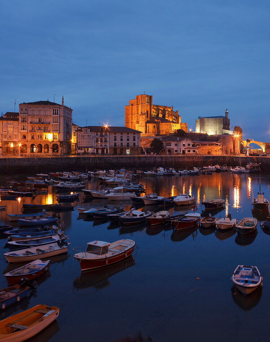 Boats at fishing port and the church Iglesia de Santa Maria de Asuncion in the evening, Castro Urdiales, Camino de la Costa, Camino del Norte, coastal route, Way of St. James, Camino de Santiago, pilgrims way, province of Cantabria, Cantabria, Northern Sp