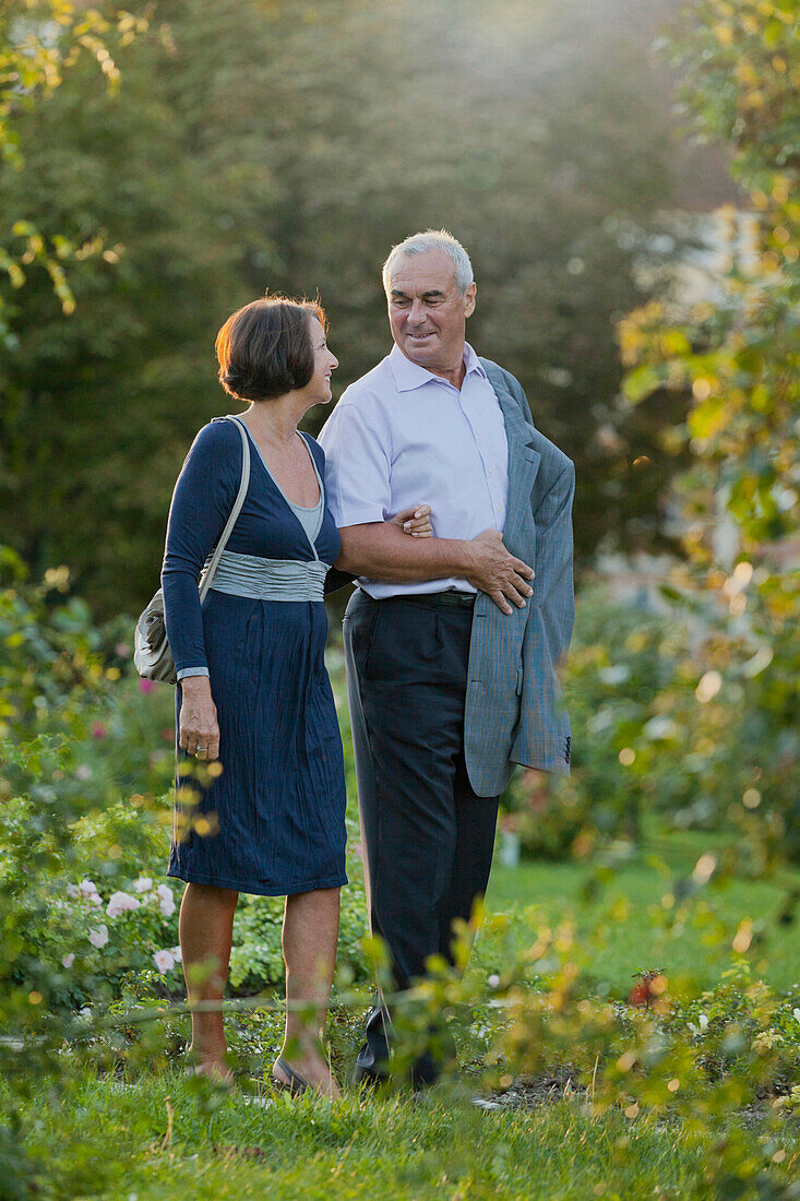 Couple walking arm in arm through Doblhoffpark, Baden near Wien, Lower Austria, Austria