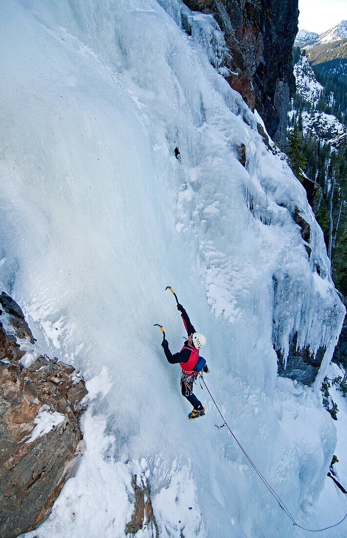Man ice climbing a route called Tobacco Gully which is rated WI3 and located near Rock Creek in the Elkhorn Mountains in eastern Oregon