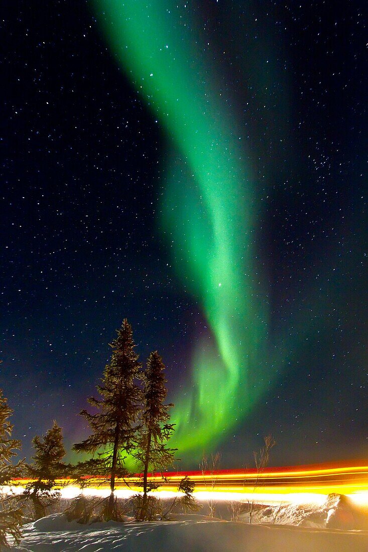 Aurora Borealis Northern Polar Lights with truckers lights on the ice road outside Yellowknife, Northwest Territories, Canada, MORE INFO The term aurora borealis was coined by Pierre Gassendi in 1621 from the Roman goddess of dawn, Aurora, and the Greek n