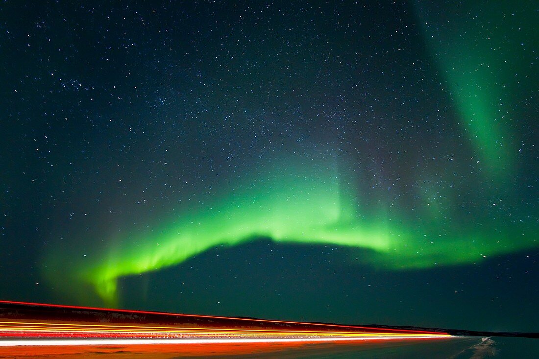 Aurora Borealis Northern Polar Lights with truckers lights on the ice road outside Yellowknife, Northwest Territories, Canada, MORE INFO The term aurora borealis was coined by Pierre Gassendi in 1621 from the Roman goddess of dawn, Aurora, and the Greek n