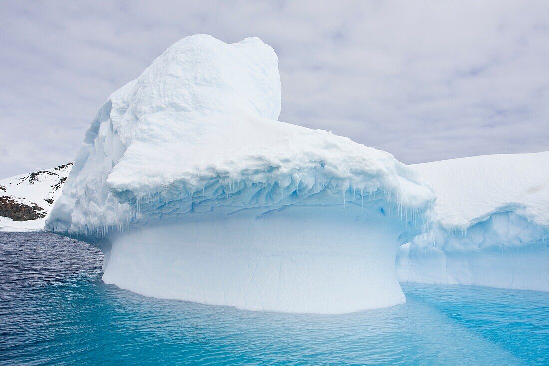 Wind and sea create fanciful iceberg designs near the Antarctic Peninsula during the summer months  More icebergs are being created as global warming is causing the breakup of major ice shelves and glaciers