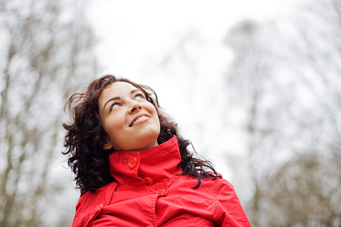 Content woman looking at the sky in the park