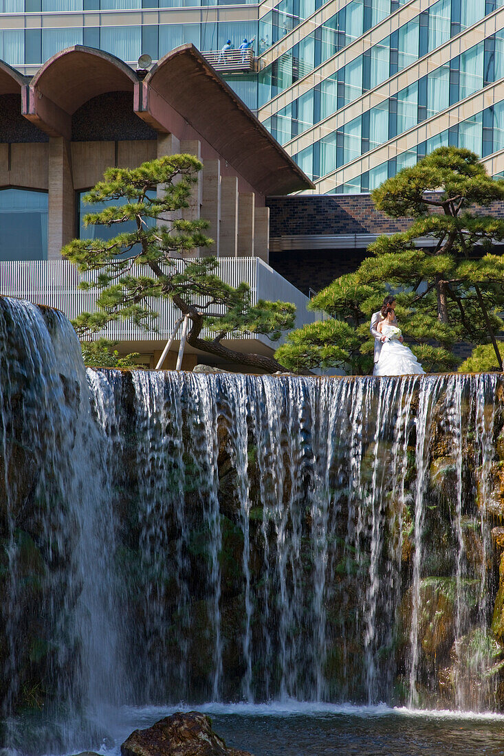 Young newlyweds have their picture taken at the traditional Edo-era Japanese garden, once a samurai lord's residence, located inside the New Otani Hotel in the upscale Akasaka district of central Tokyo, Japan.