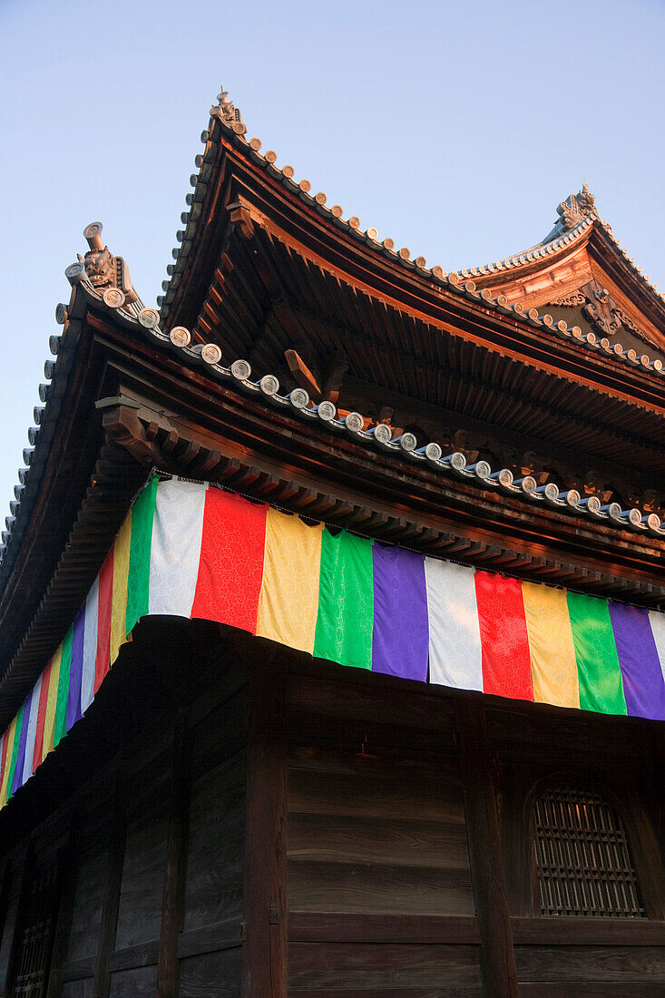 Colorful silk noren curtains hang under the eaves at Myoshinji Temple, located in the northern area of Kyoto, Japan.