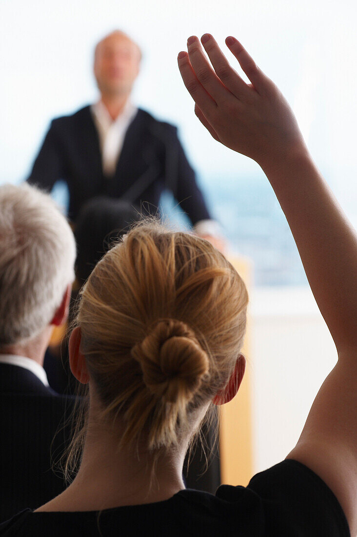 Woman raising her arm for a question. Woman raising her arm for a question