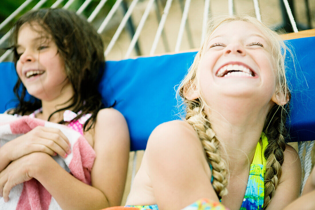 2 young girls laughing in hammock. 2 young girls laughing in hammock