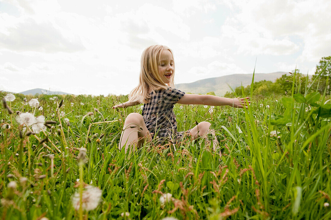 Child playing in field in springtime