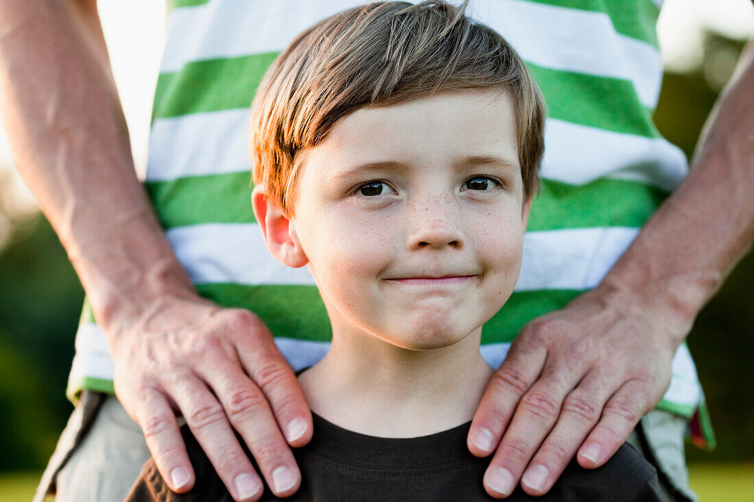 Father With Hands On Sons Shoulders