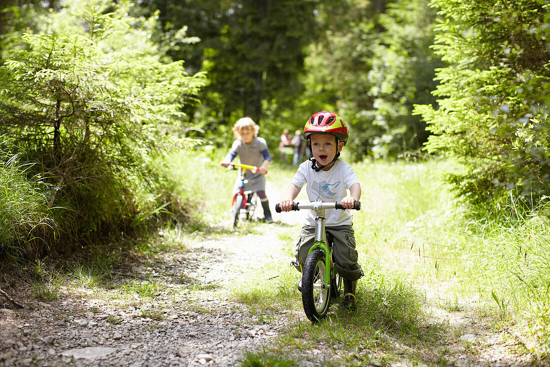 Toddler boy riding bike on dirt path. Toddler boy riding bike on dirt path