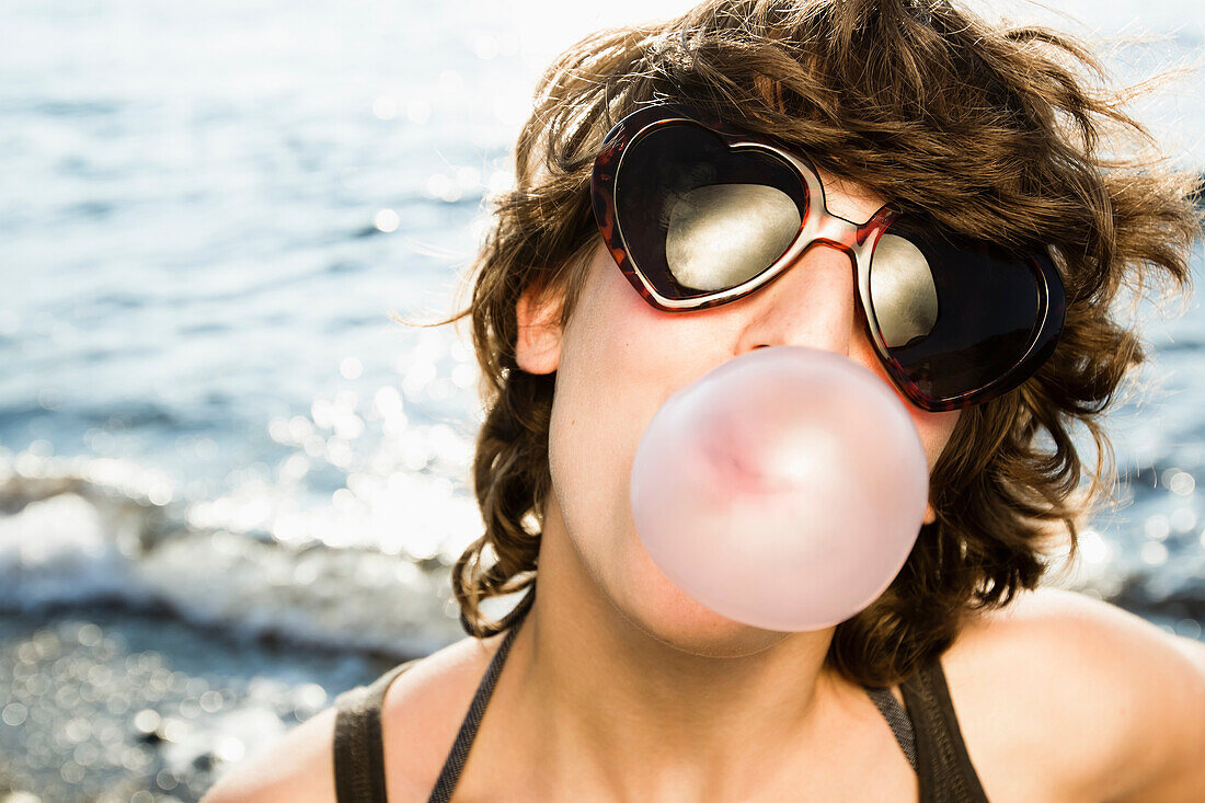 Woman blowing bubble on beach. Woman blowing bubble on beach