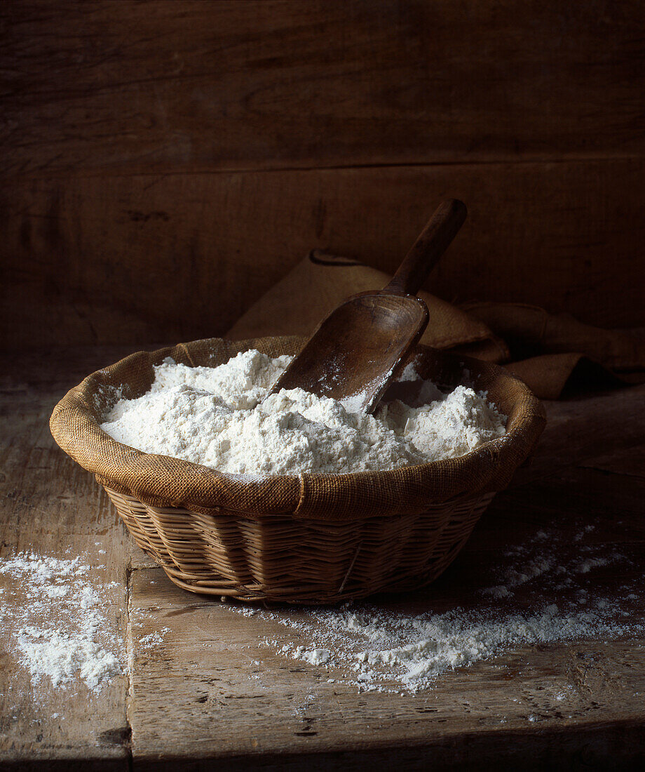 Organic flour in basket. Organic loose flour in hessianbasket with scoop