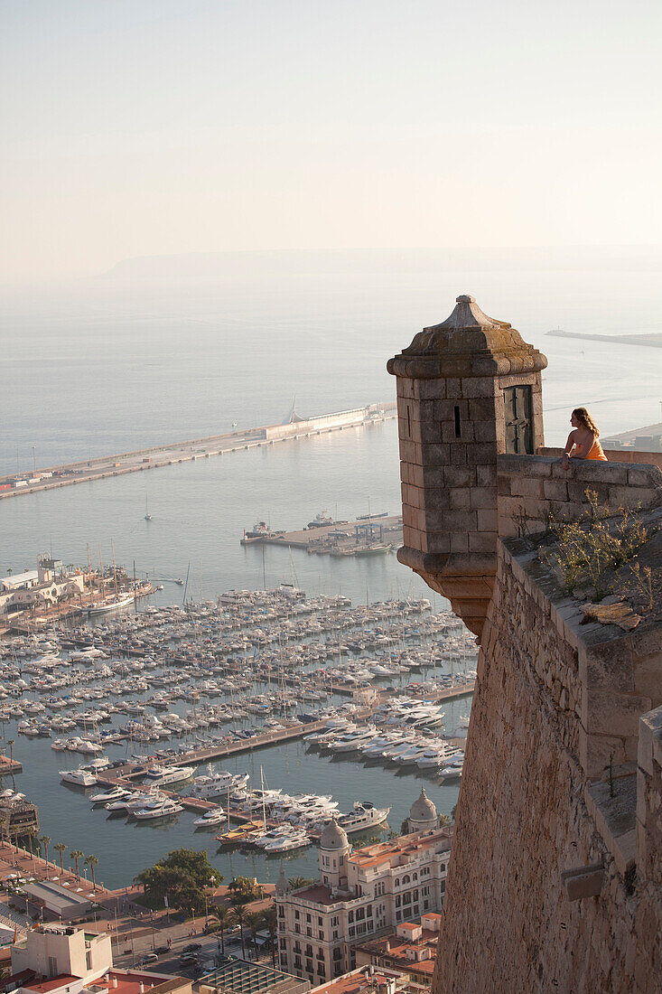 Woman admiring view from castle. View from Santa Barbara Castle, Alicante, Spain