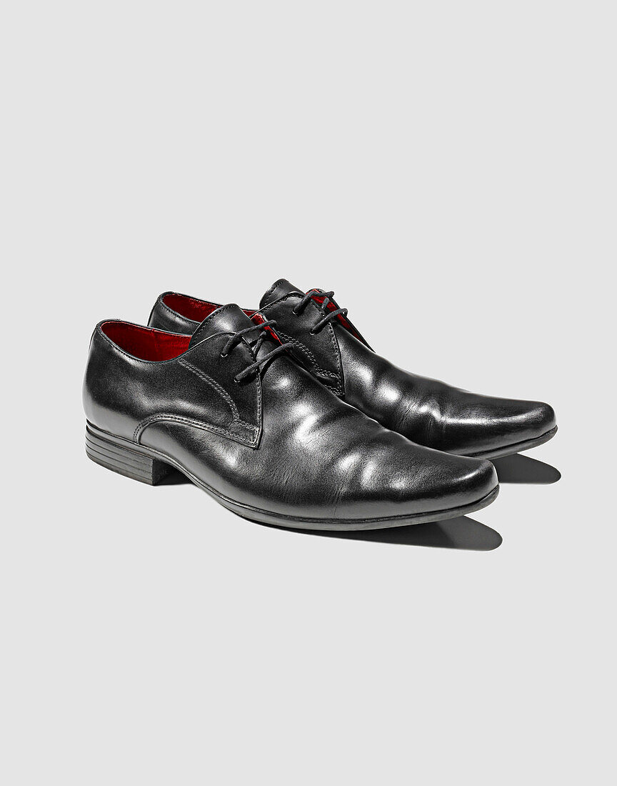 Close up of mans dress shoes. Still Life,Shoes,Black,Red,Smart, Business,shinny,shine,fashion,Graphic,Shadows,Photograph