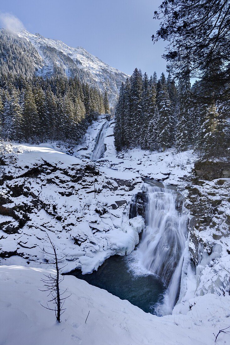 The Krimml waterfalls in the National Park Hohe Tauern during winter in ice and snow  The middle Fall  The Krimml waterfalls are one of the biggest tourist attractions in Austria and the Alps  They are visited by around 400 000 tourists every year  The wa