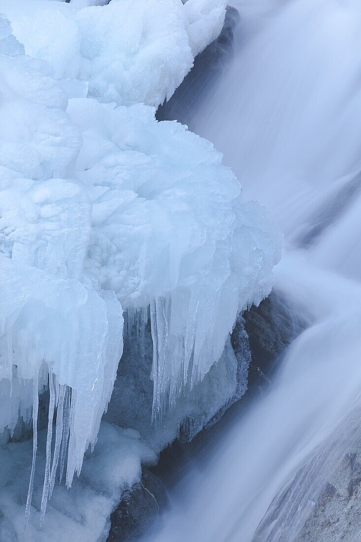 The Krimml waterfalls in the National Park Hohe Tauern during winter in ice and snow  Detail of the middle Fall  The Krimml waterfalls are one of the biggest tourist attractions in Austria and the Alps  They are visited by around 400 000 tourists every ye