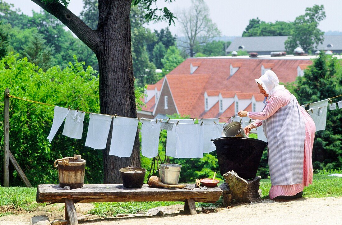 Woman washing linen in Old Salem Moravian religious community founded 1766, in modern city of Winston Salem, North Carolina, USA