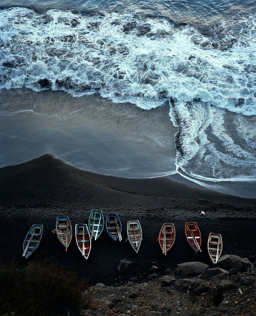 View from a plateau at the old town of Sao Filipe onto fishing boats on lava beach, Island of Fogo, Ilhas do Sotavento, Republic of Cape Verde, Africa