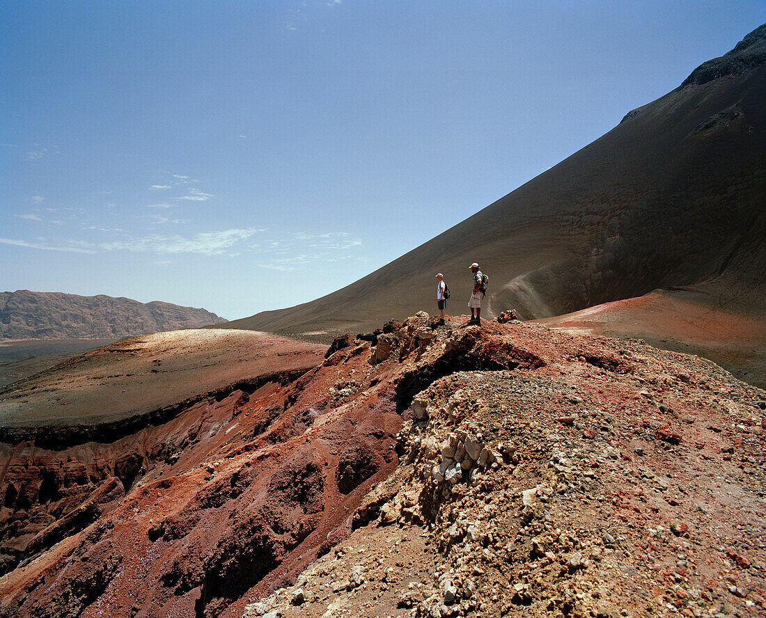 Hikers on ashfield in the Cha das Caldeiras underneath Pico Pequeno, Island of Fogo, Ilhas do Sotavento, Republic of Cape Verde, Africa