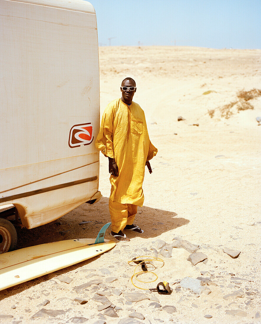 Senegalese musician in front of Joao's surf truck, surf spot Ponta Preta, west of Santa Maria, Sal, Ilhas de Barlavento, Republic of Cape Verde, Africa