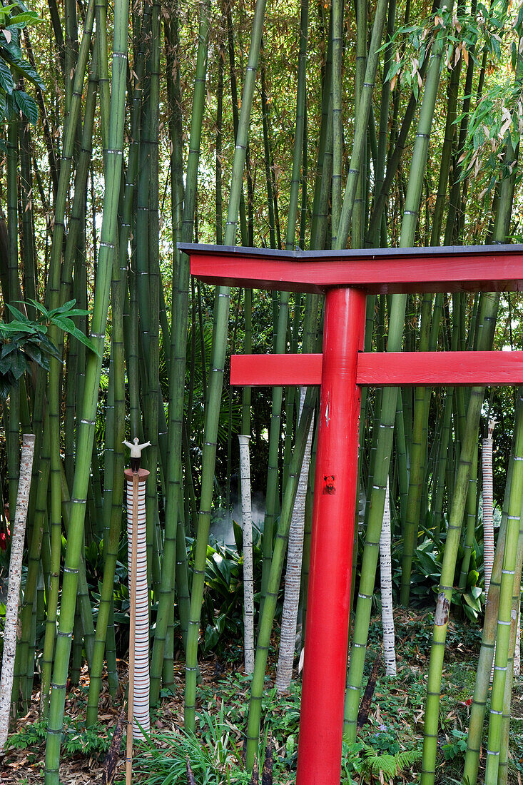 Chinese gate in front of baboo forest with sculptures of Mariano Fuga at Andre Hellers' Garden, Giardino Botanico, Gardone Riviera, Lake Garda, Lombardy, Italy, Europe