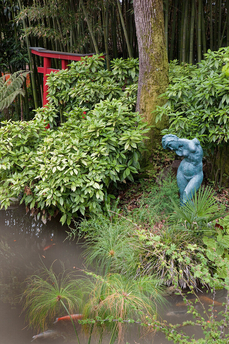 Chinese gate and Auguste Rodin sculpture at a pond at Andre Hellers' Garden, Giardino Botanico, Gardone Riviera, Lake Garda, Lombardy, Italy, Europe