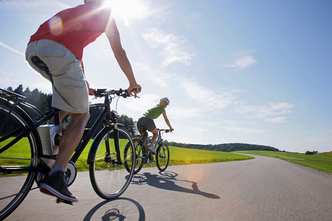 Young woman and young man on an e-bike, Lake Starnberg, Upper Bavaria, Germany