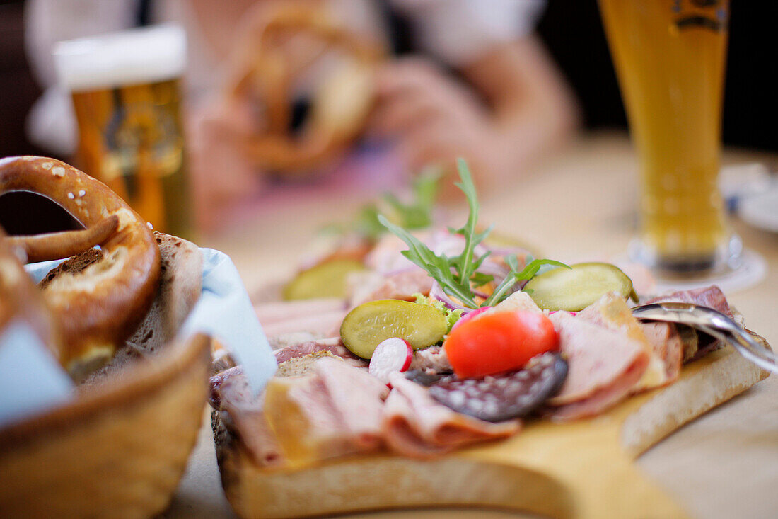 Close up of a snack with pretzel and beer