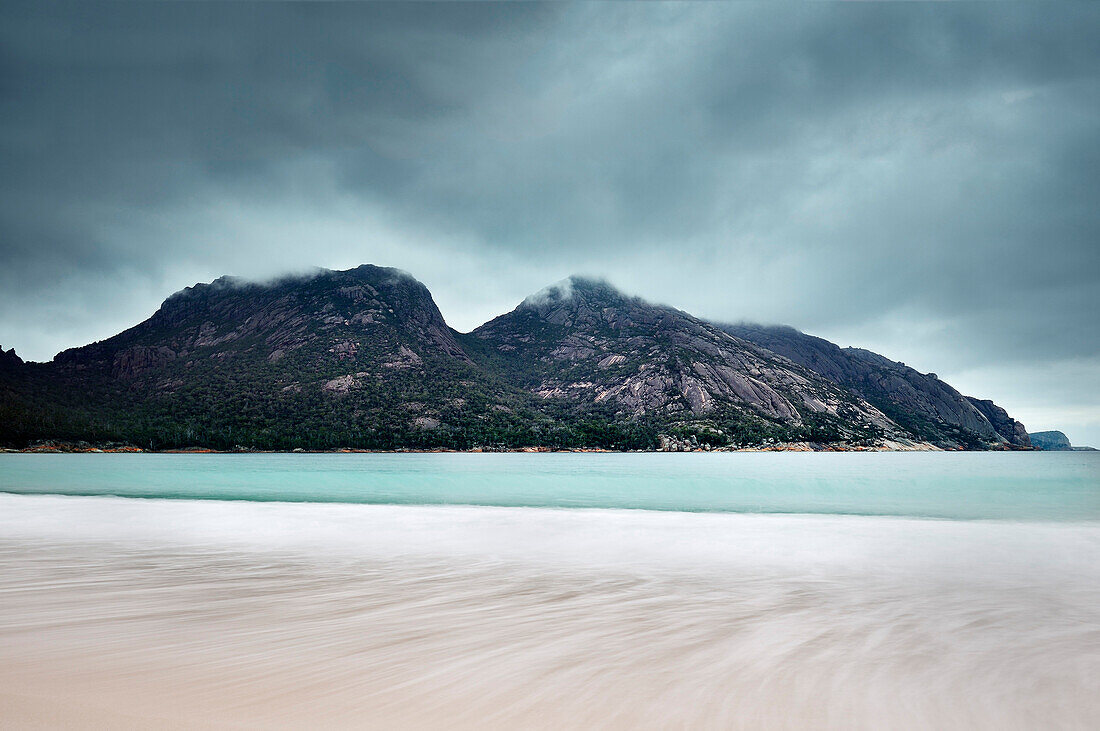 View of Mt Amos and Wineglass Bay from the beach, Freycinet National Park, Tasmania, Australia