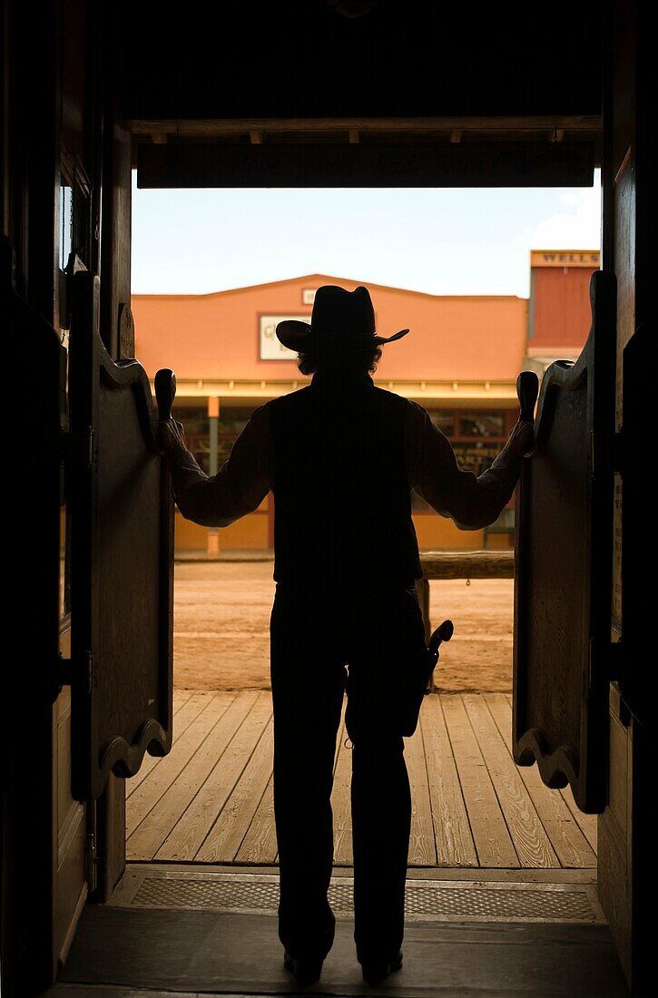 SILHOUETTE OF COWBOY STANDING IN DOORWAY OF SALOON ALLEN STREET TOMBSTONE COCHISE COUNTY ARIZONA USA