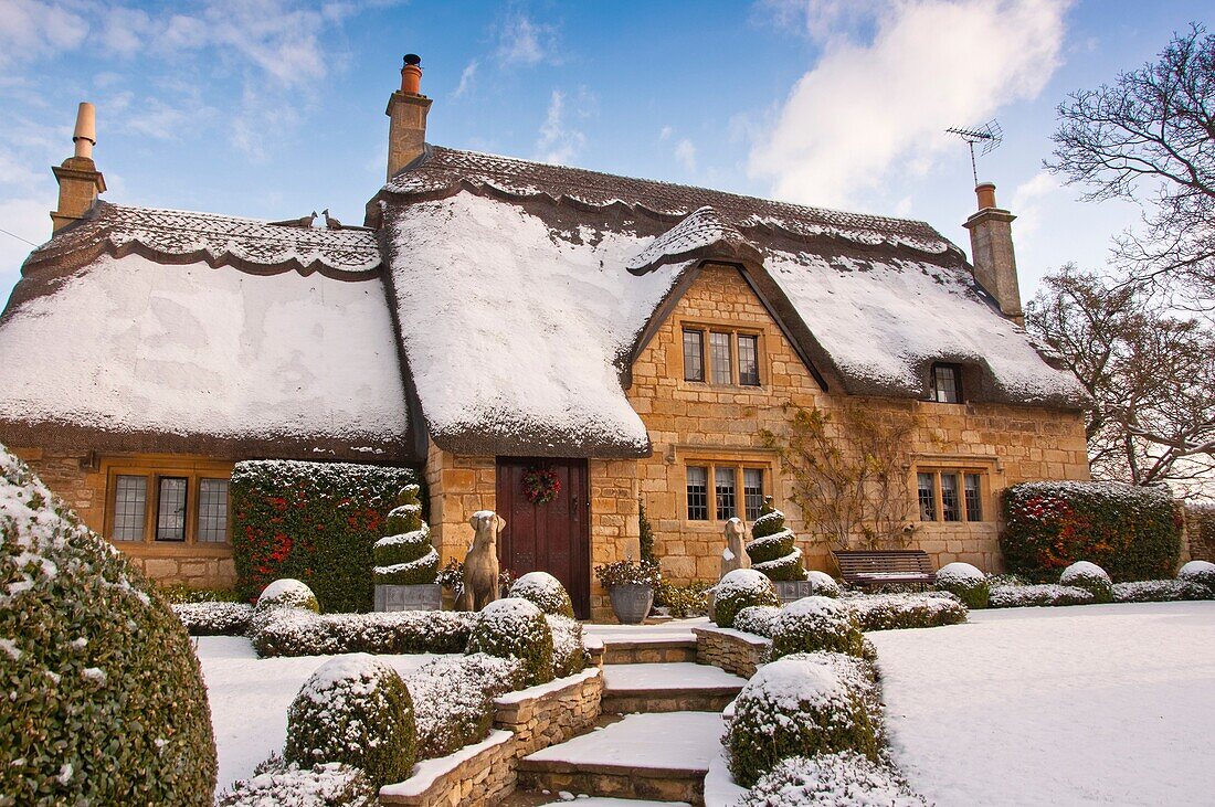 A thatched cottage covered in snow on the edge of the Cotswold village of Chipping Campden  England