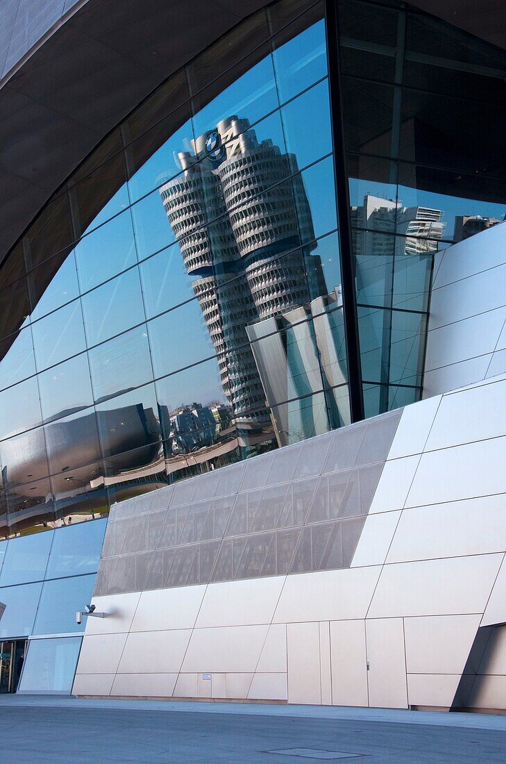 BMW HQ and museum reflected in the BMW Welt building, Munich, Germany