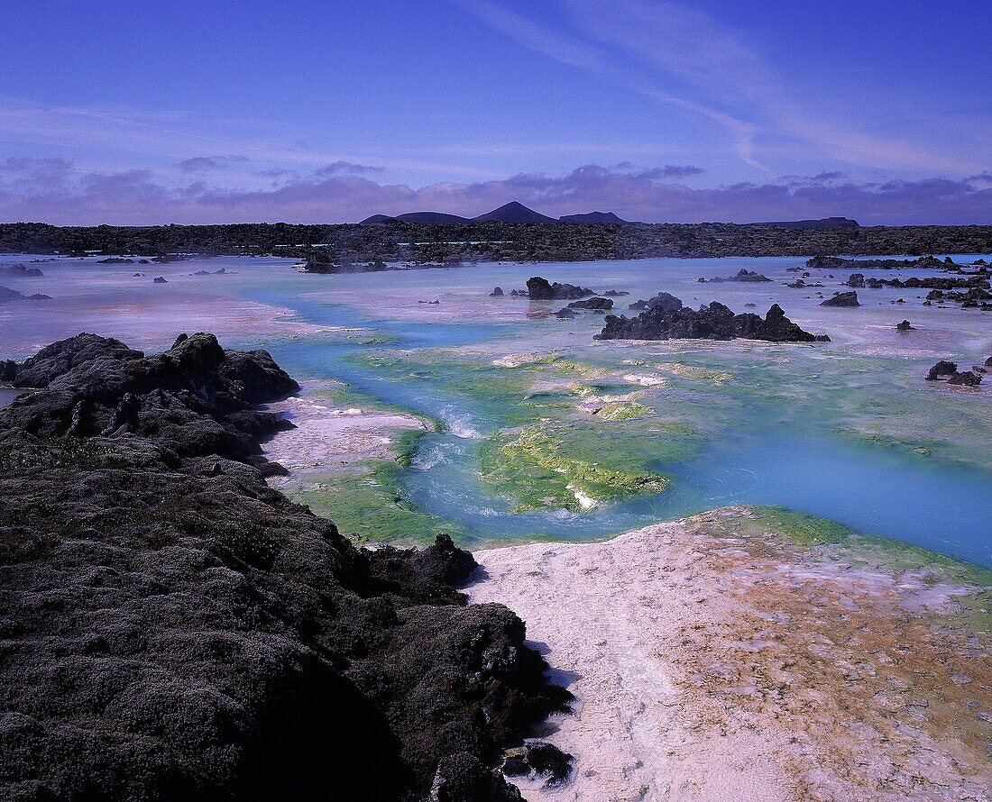 Algae, silica, minerals surrounded by lava rock  Geothermal area close by Blue Lagoon bathing hot springs, Reykjanes Peninsula, Iceland