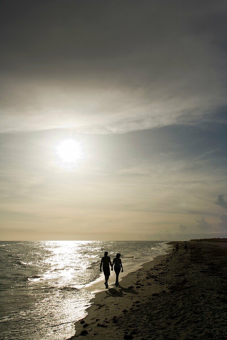 Couple walking hand-in-hand down Bowman´s Beach - Sanibel Island, Florida