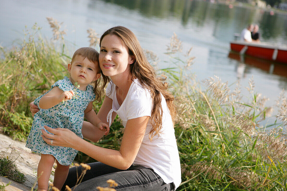 Young mother with daughter at Danube riverbank, Old Danube, Vienna, Austria