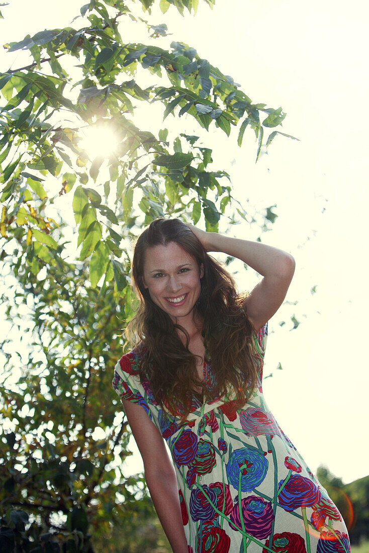 Smiling young woman wearing a summer dress, Old Danube, Vienna, Austria