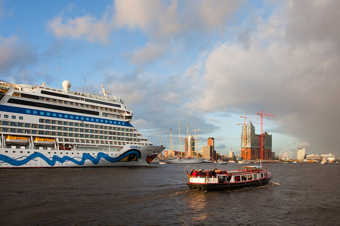 Cruise ship AIDAblu entering port in front of Hafen City and Elbphilharmonie, Hamburg, Germany, Europe