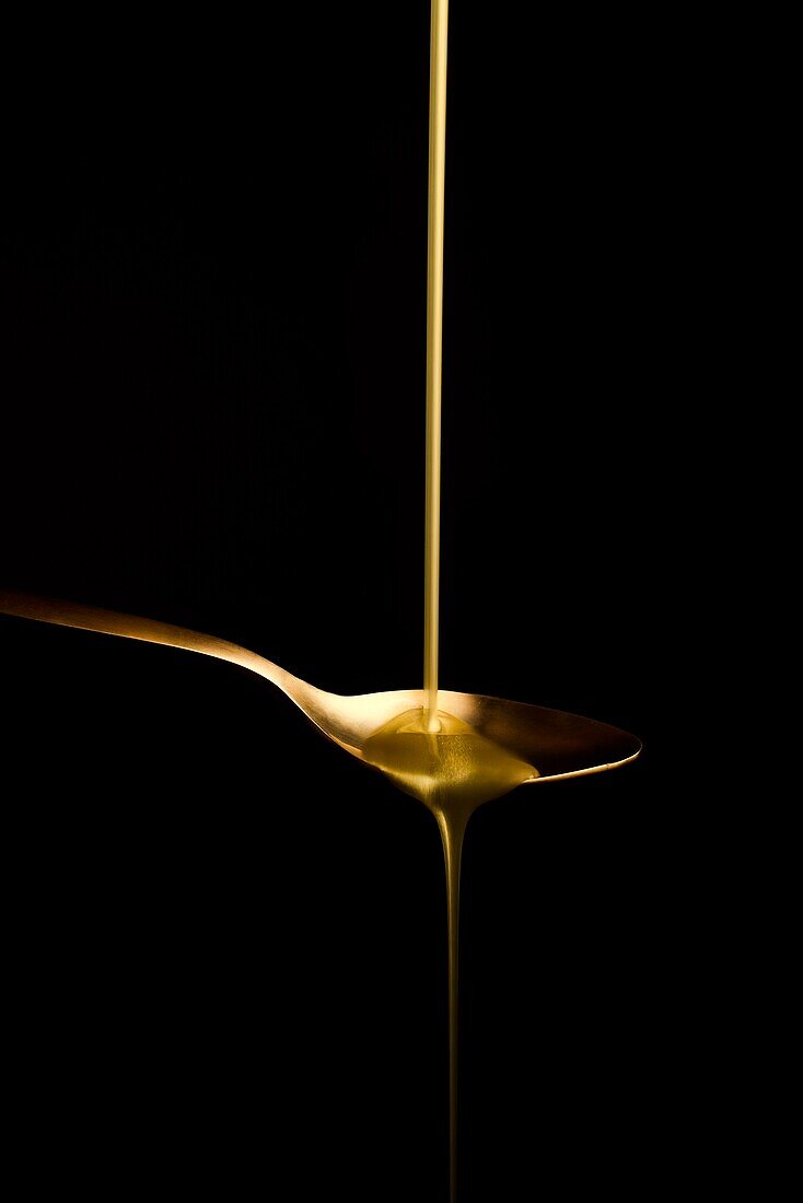 goldy liquid in a goldy spoon