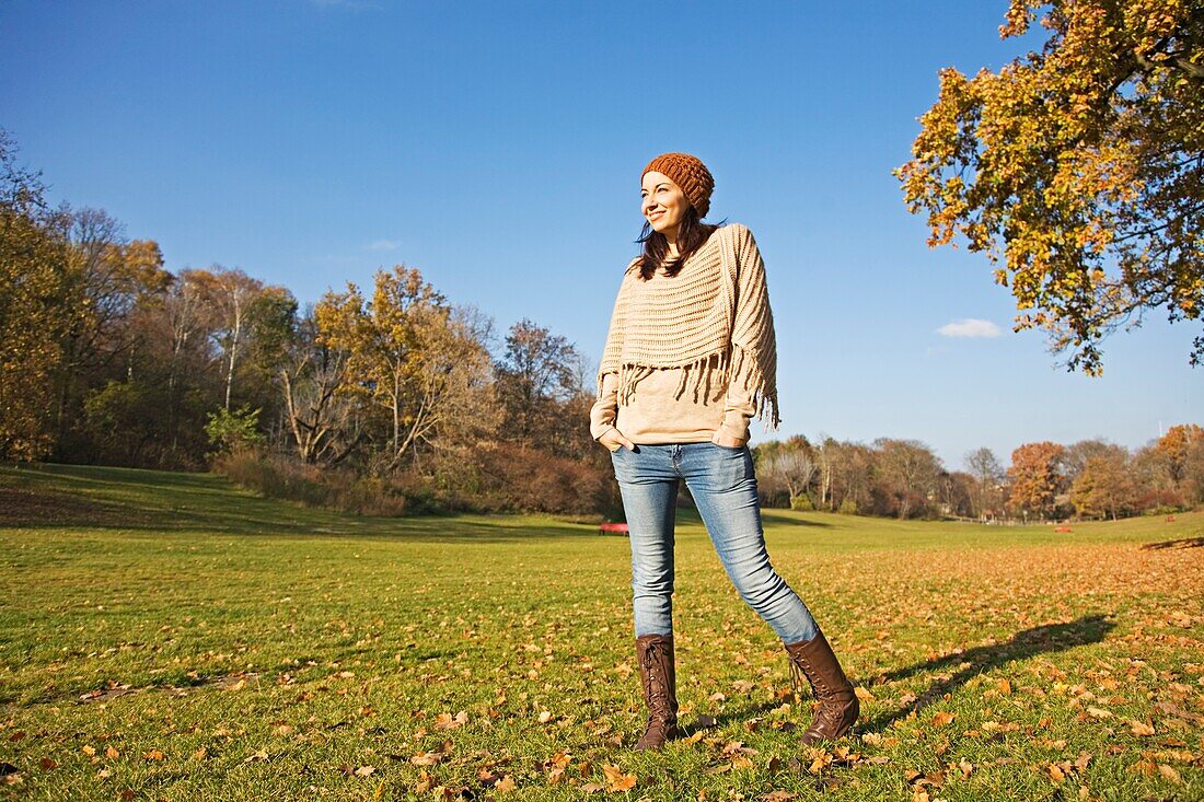 Portrait of a brunette woman in park in Autumn smiling