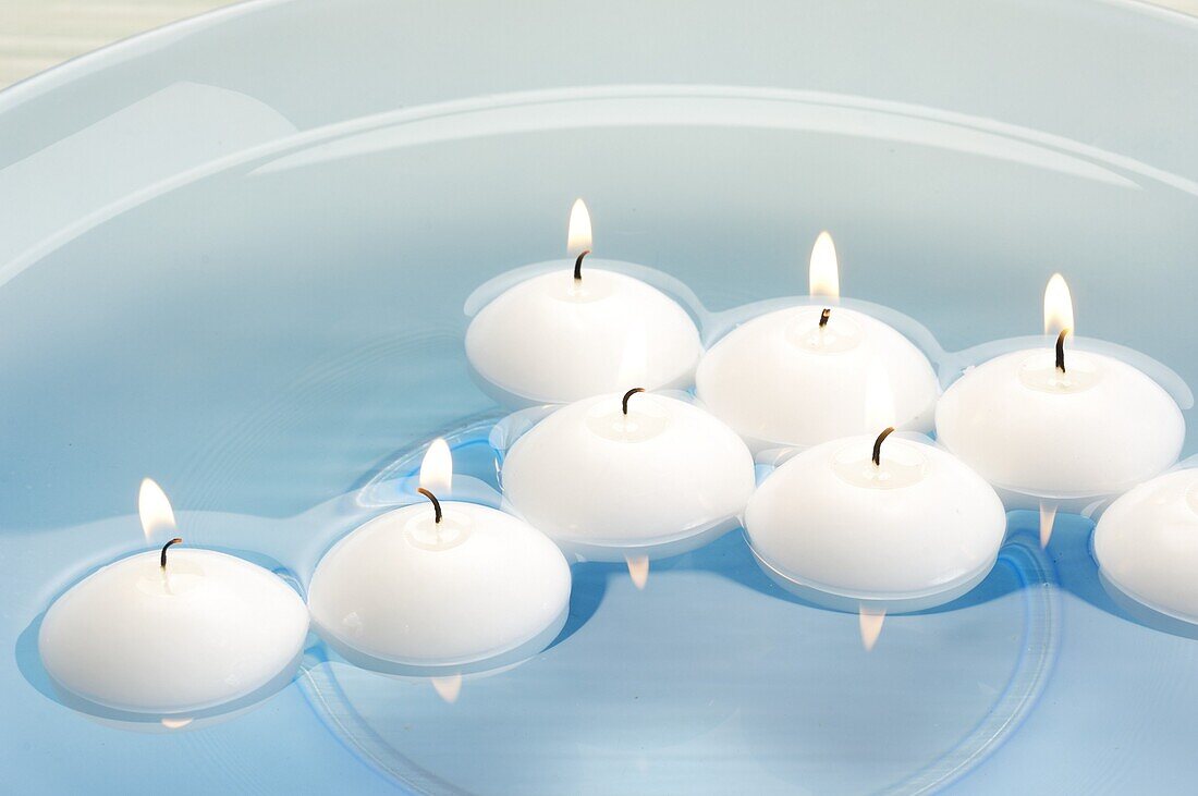 Floating candles in a blue bowl