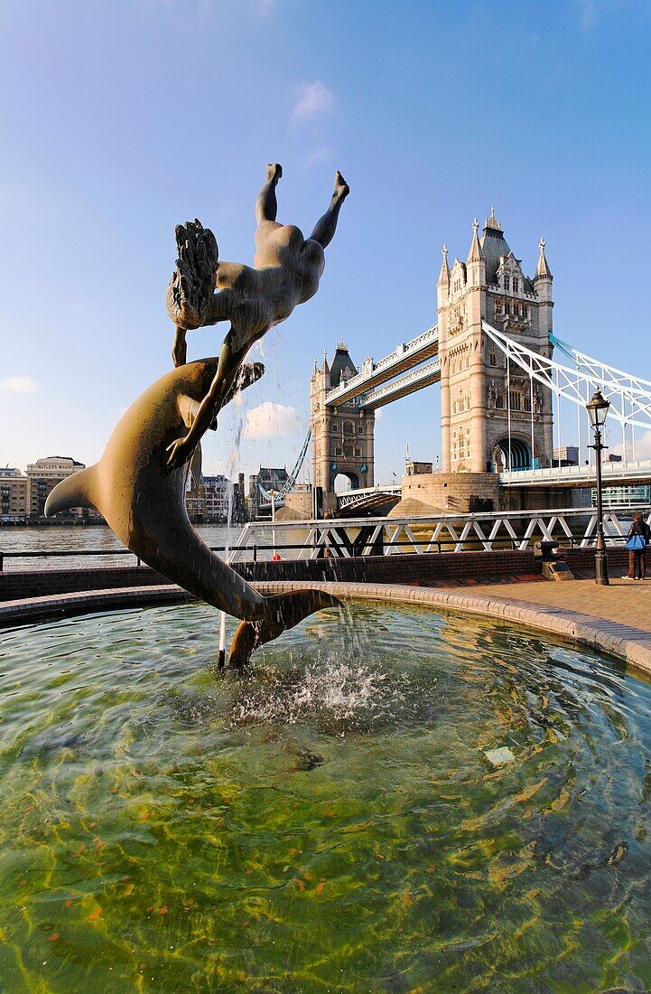 Tower Bridge and Girl Playing With Dolphin statue, London, UK