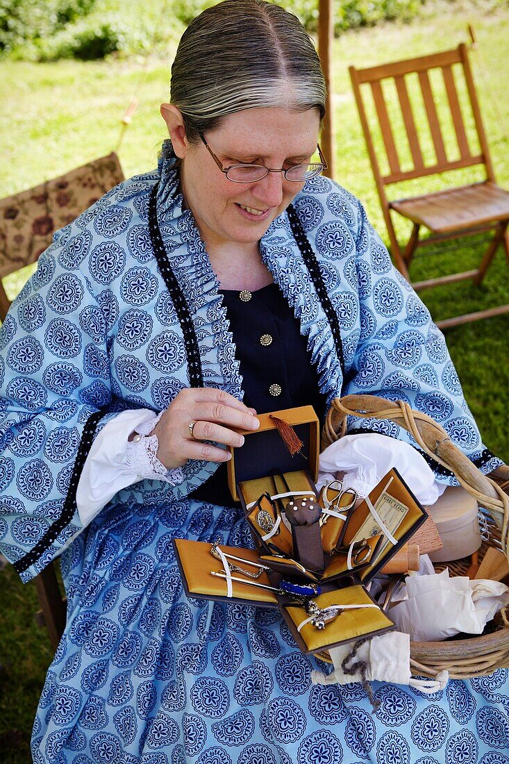 A reenactor portraying a seamstress in the Civil War encampment at historic Blenheim, Fairfax, Virginia