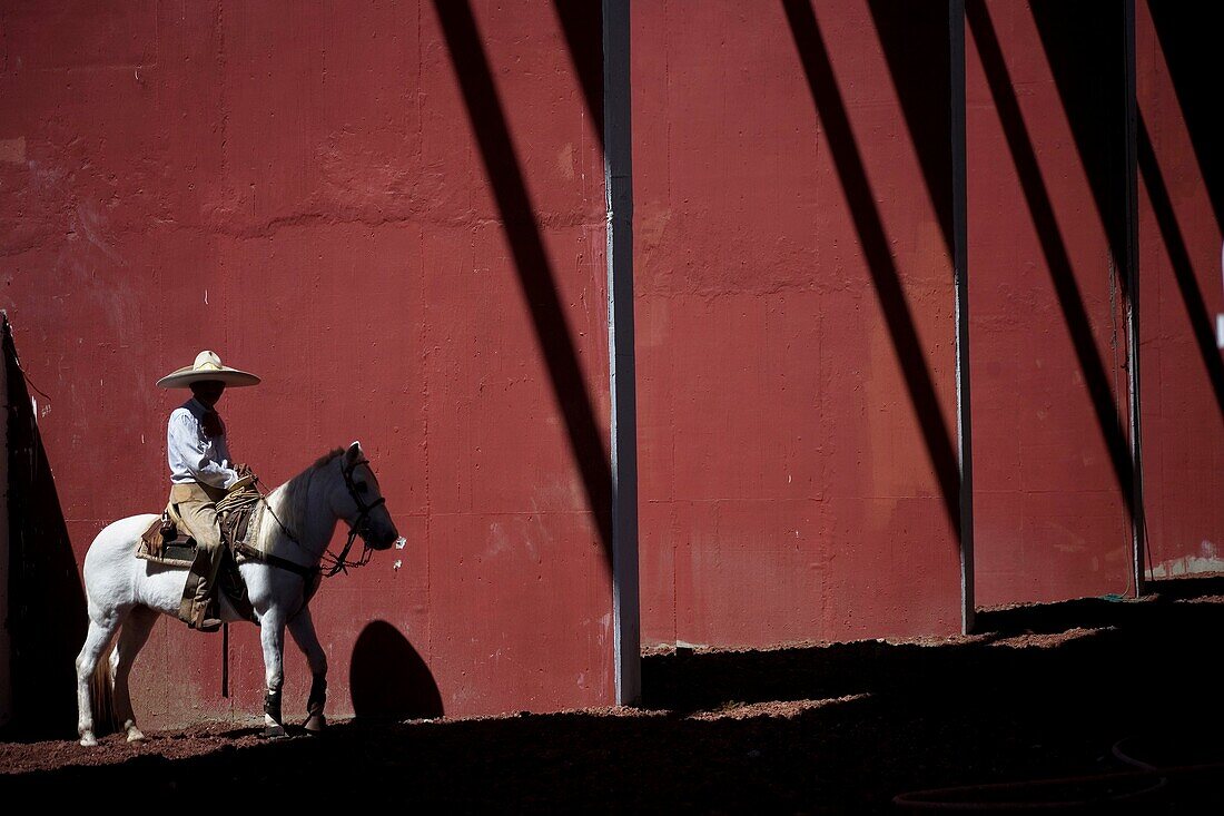 A Mexican charro ride his horse at the National Charro Championship in Pachuca, Hidalgo State, Mexico. Escaramuzas are similar to US rodeos, where female competitors called ´Amazonas´ wear long skirts, and ride side saddle Male rodeo competitors are ´Char