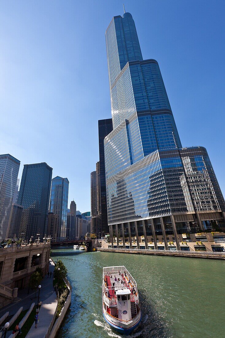 Chicago River boat passes the Trump International Hotel & Tower in Chicago, IL, USA