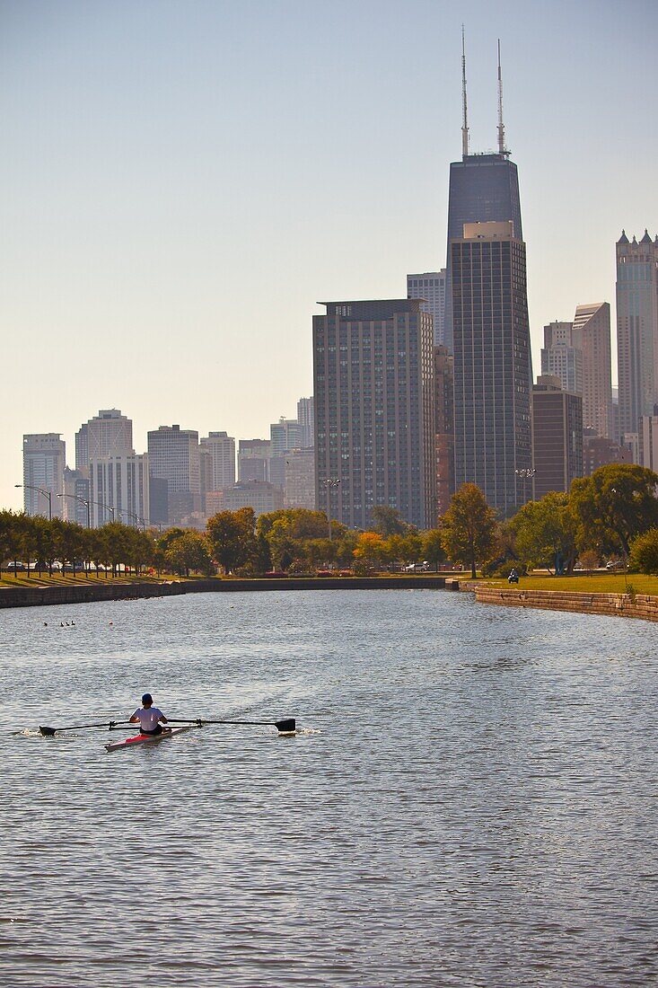 A rowing shell in Lincoln Park with the Chicago skyline