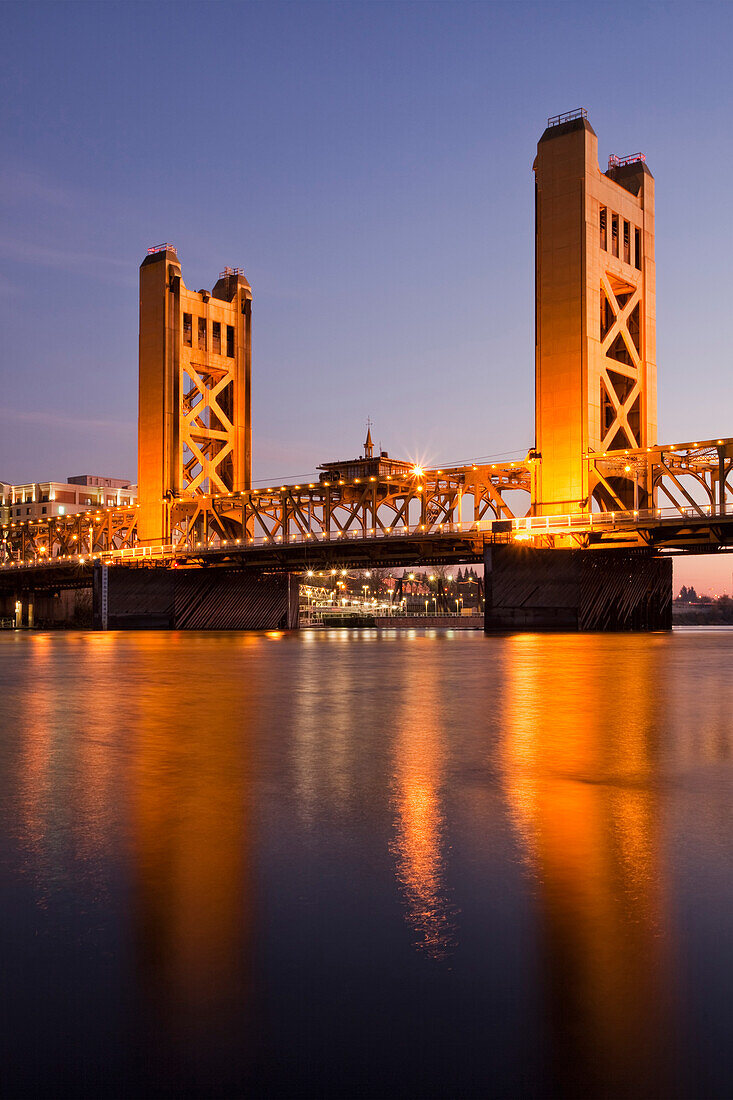 Tower Bridge, Sacramento, California, USA. A road bridge with tall towers and a metal framework arch. Sunset. Dusk., Tower Bridge over the Sacramento River
