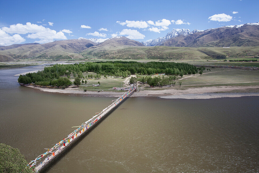 A long bridge across the river near Ganzi. A wide river. Horsehoe bend in the river course. Valley and mountain scenery., Sichuan Tibet
