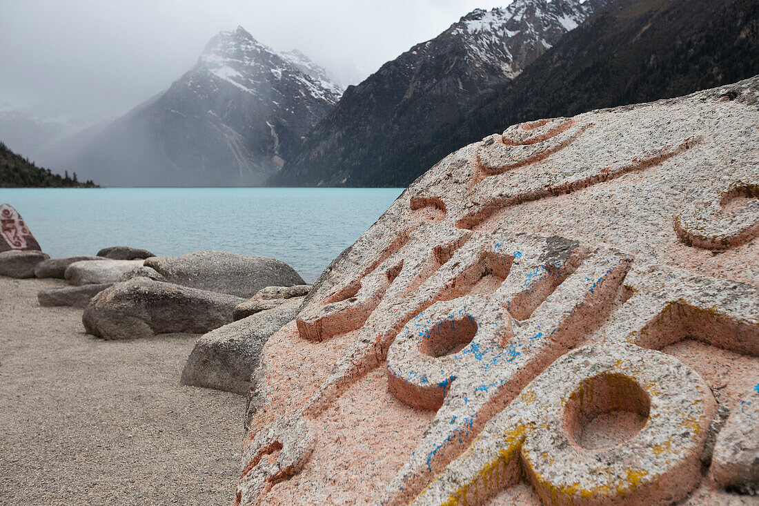 Giant Mani rocks beside the Yihun Lhatso, a holy alpine lake in a valley beside the road between Manigango and Dege. Inscriptions and prayers, roadside shrine., Sichuan Tibet